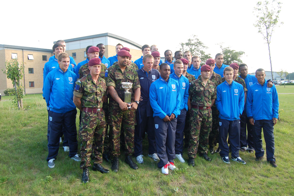 England's Under-21 players pose alongside the Army Football Cup.